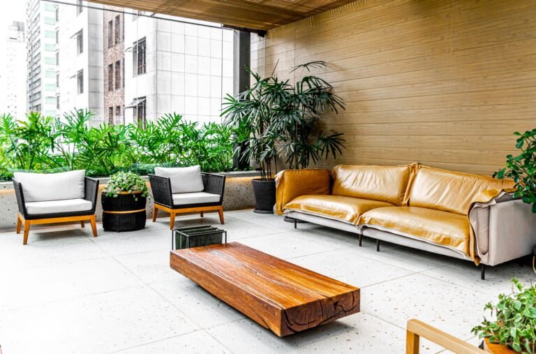 Stylish indoor patio in São Paulo featuring modern furniture and lush greenery.